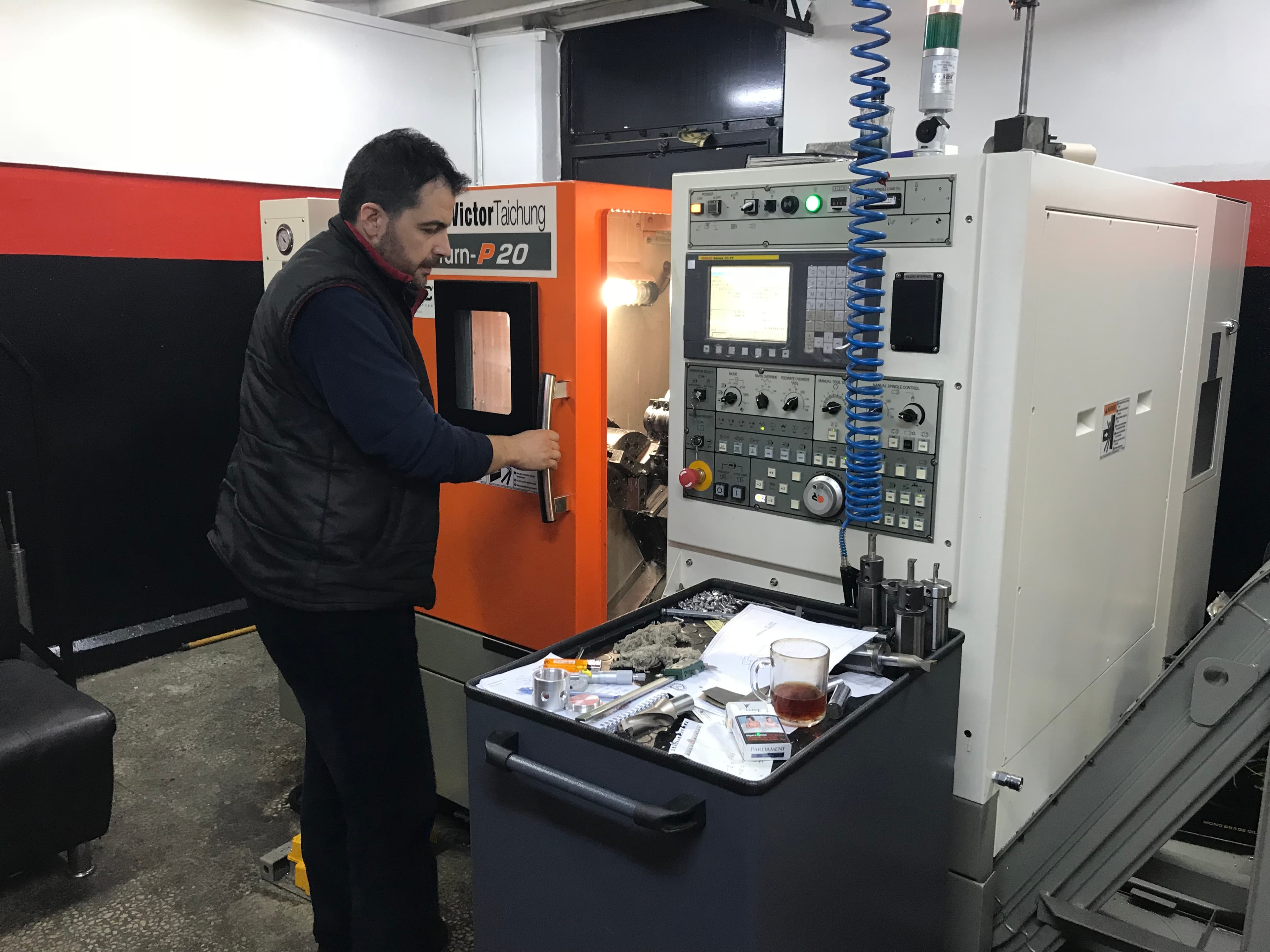 Engineer operating CNC turning center at OrderCAD workshop